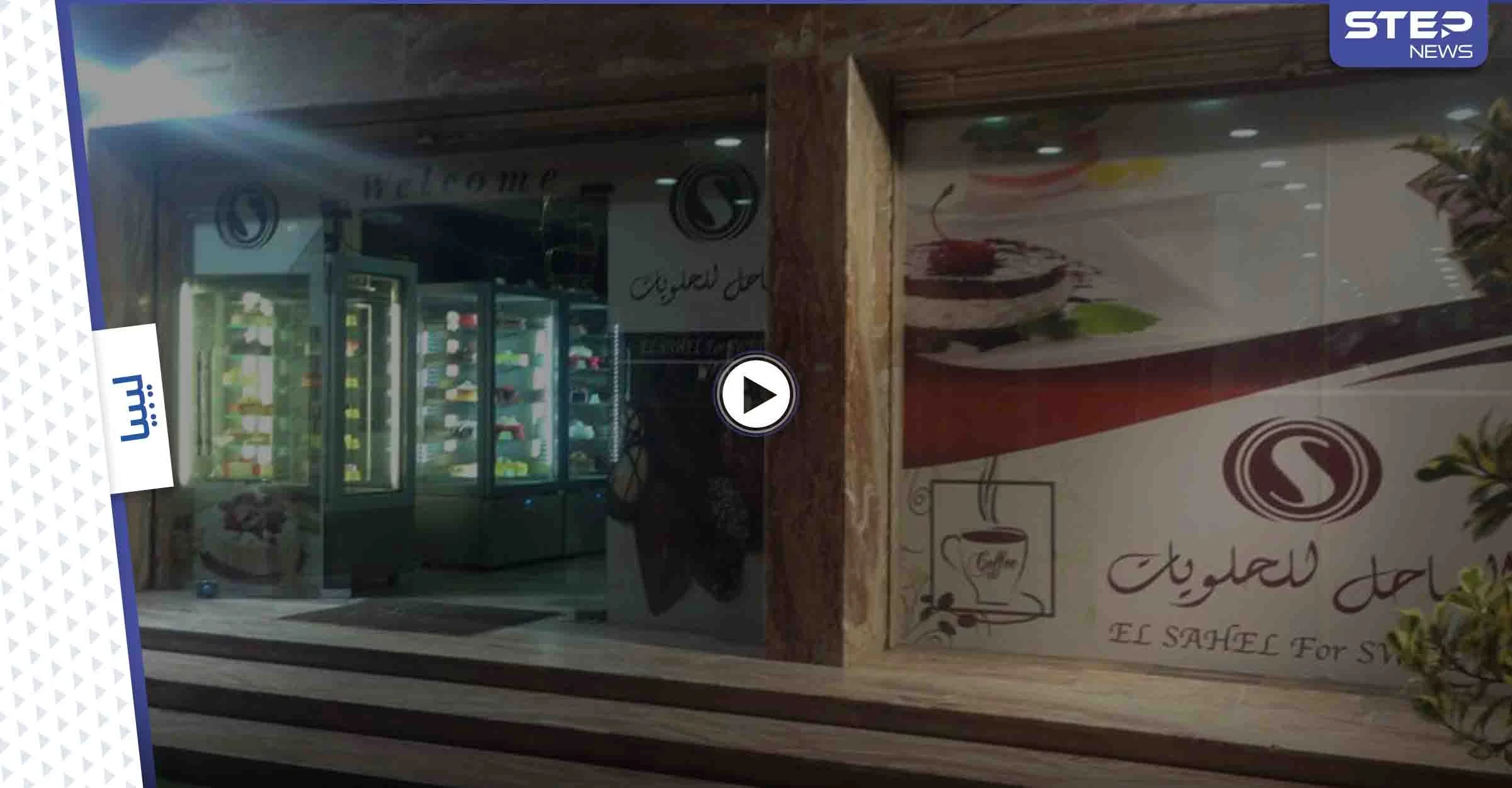 بالفيديو|| امرأة تضع السحر وتقوم بحركات وشعوذات غريبة أمام مجموعة الساحل للحلويات في طرابلس