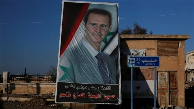 عناصر باللباس المدني يزيلون صور بشار وماهر الأسد من حلب الشرقية، والتفاصيل!!؟